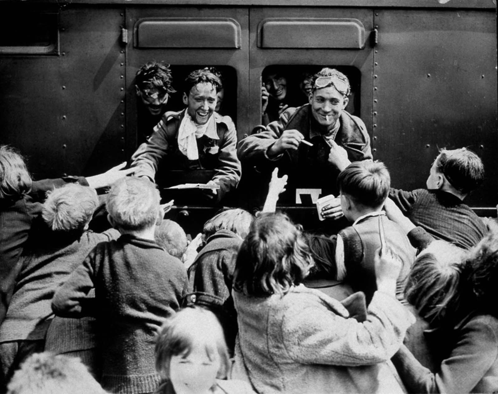 Children greet returning British soldiers.