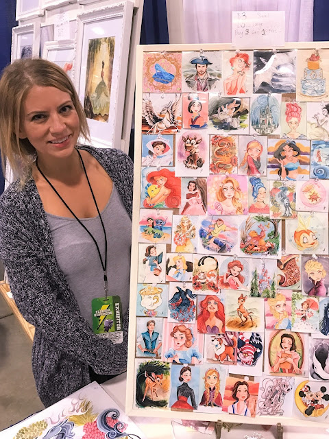 Megan Withey standing next to her Disney inspired artwork.