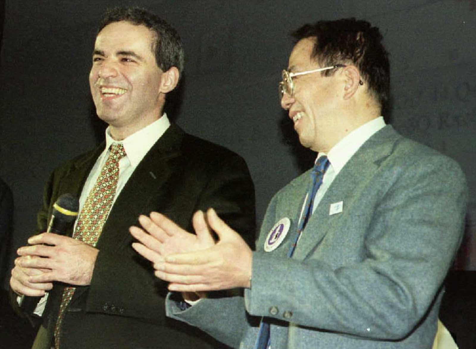 Deep Blue developer Dr. Chung-Jen Tan applauds Garry Kasparov after his victory over the supercomputer in the six-game match.