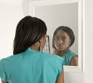 A Lady Inspects Her Facial Skin For Acne