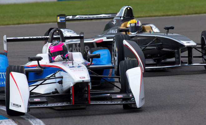 Two Formula E cars contest a corner