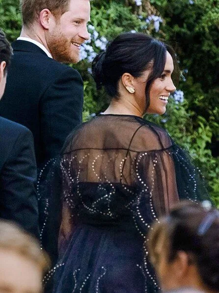 Meghan Markle wore an £8,900 black puff sleeved embroidered tulle gown by Valentino. Princesses Eugenie and Beatrice