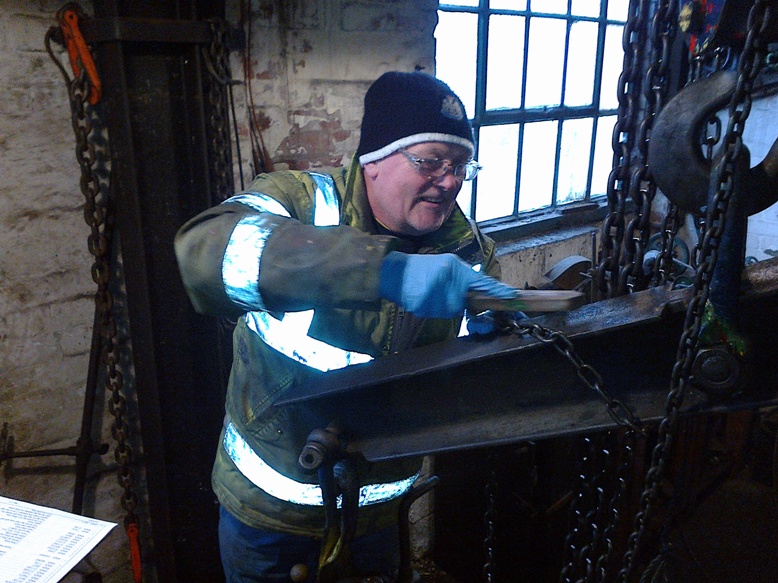 A Towne engineer inspecting lifting tackle