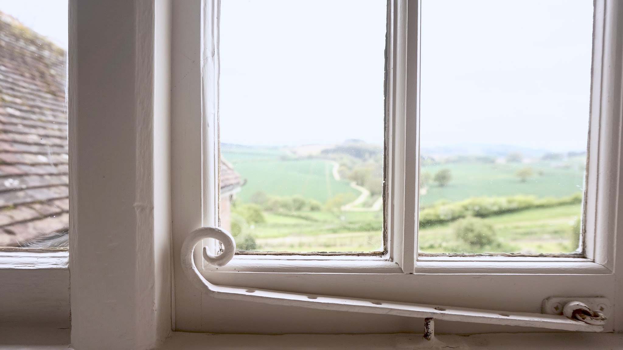 scenic view of the English countryside through an old fashioned window