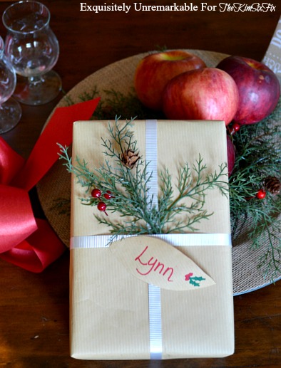 embellishing Christmas presents with evergreen sprigs
