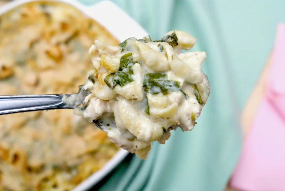 Fresh spinach and marinated artichokes make this creamy cheesy chicken casserole extra special!