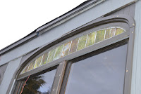 New zinc came and colored glass panels in upper sashes.