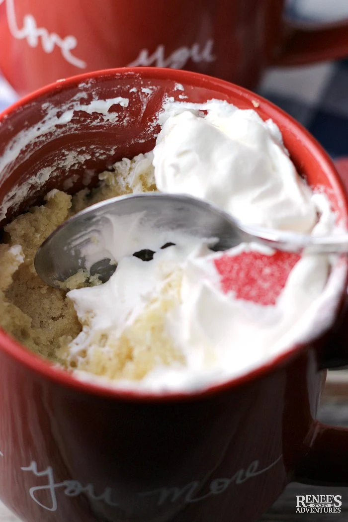 Digging into Vanilla Cake in a red Mug (for Two) with a spoon