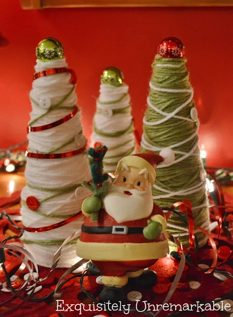 Christmas Yarn Trees behind a Santa figurine