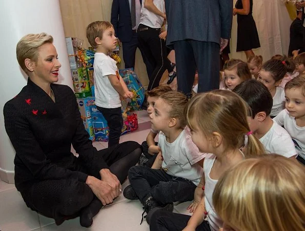 Prince Albert and Princess Charlene visited the kindergarten of Red Cross, children new year gifts. Princess Charlene Valentino dress