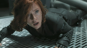 Scarlett Johansson lying down in her black catsuit in The Avengers 2012 movieloversreviews.filminspector.com