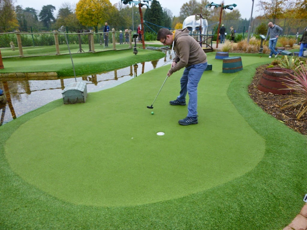 Playing a shot on a big green at Pirate Island Adventure Golf course at Hoebridge Golf Centre in Woking, Surrey Pirate Island Adventure Golf course at Hoebridge Golf Centre in Woking, Surrey