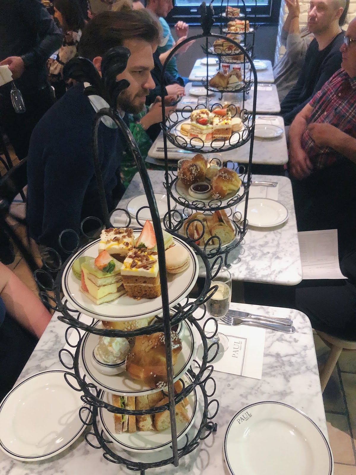 Afternoon tea with three-tiered with cakes and scones
