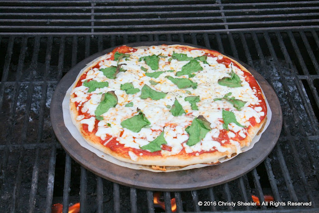 Pizza after the first 5 minutes on grill. Close grill lid.  Set timer for 5 more minutes.  