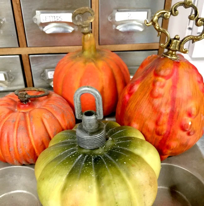 Dollar store pumpkins with added hardware stems
