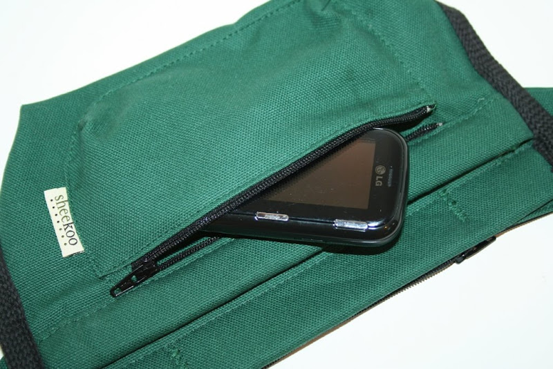 outside pocket with zipper holding a cell phone