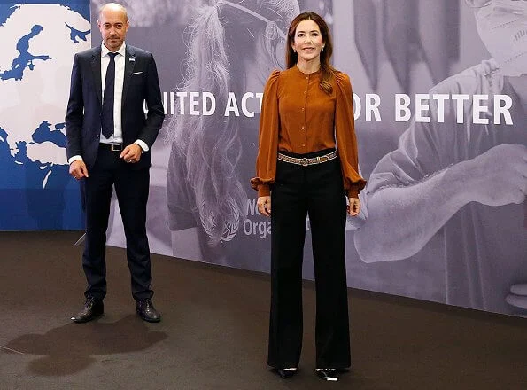 Crown Princess Mary wore a rockstud patent leather pumps by Valentino. balloon puff long sleeve silk blouse, black trousers, multicolor belt