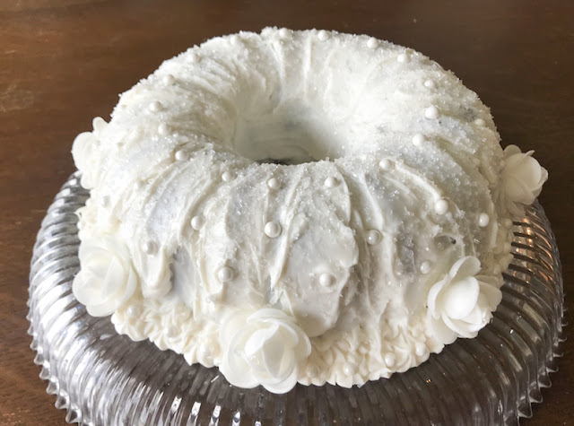 Food Lust People Love: A simple one-bowl batter is the base of this beautiful almond wedding cake, decorated with almond buttercream icing and pearl and flower flourishes.