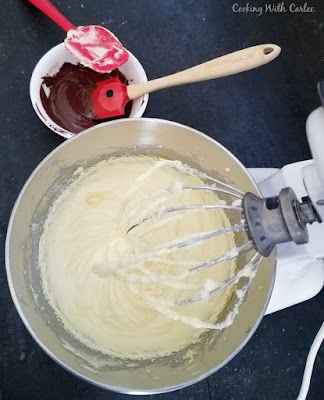 mixer bowl filled ingredients for french silk pie with melted chocolate nearby