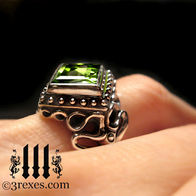 silver raven love gothic wedding ring with green peridot on model
