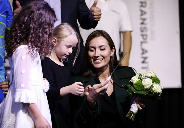 Princess Claire of Luxembourg attended the 11th Indoor Cycling Marathon. Princess Claire wore a green wool coat by Alexander McQueen