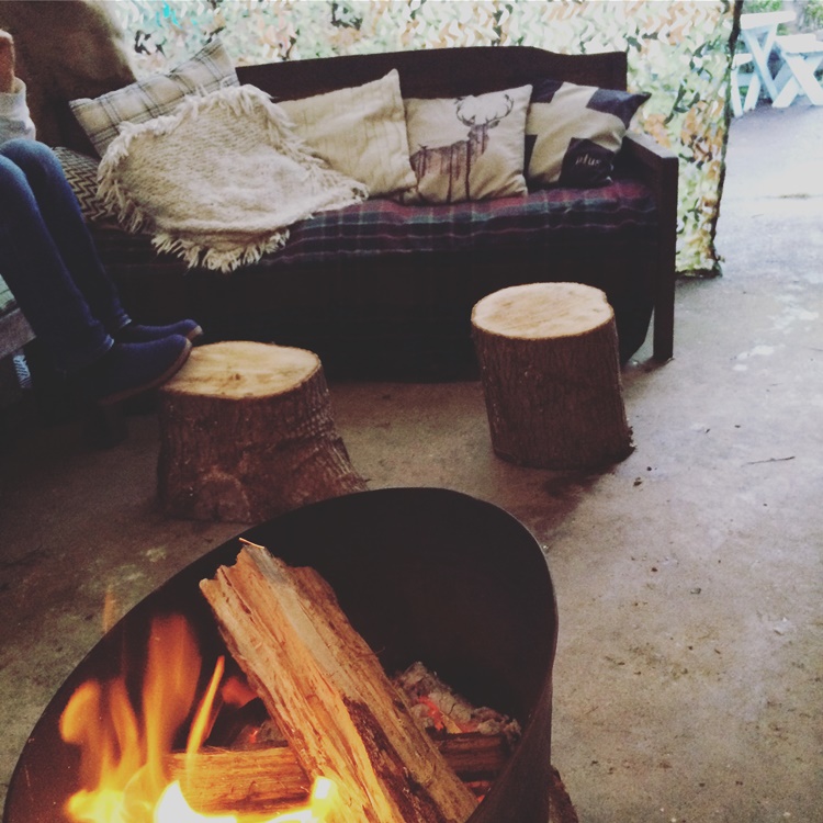 Woodland Campfire Party - cosy cushions and blankets, with log stump tables