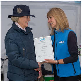 Sarah Sillars of IAM RoadSmart presents certificate to Mary Berry