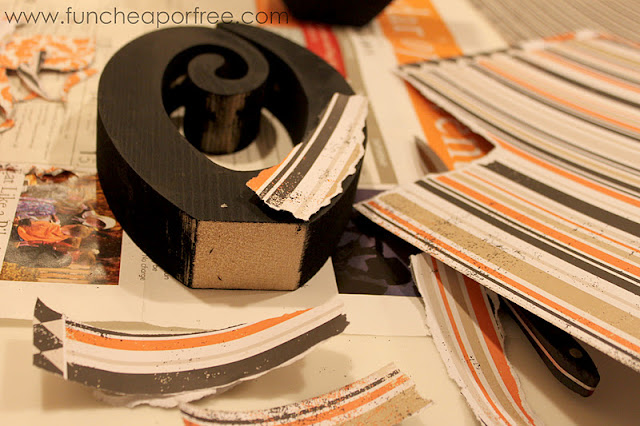 Putting scrapbooking paper on a wooden letter O, from Fun Cheap or Free