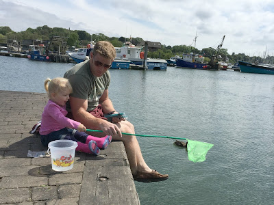 Sitting on the harbour wall with a net