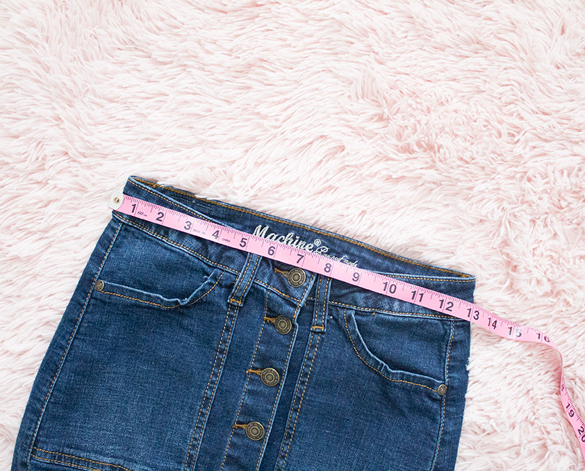 denim skirt waistband being measured with measuring tape