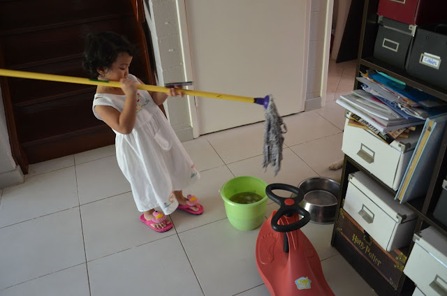 Kecil playing with the mop