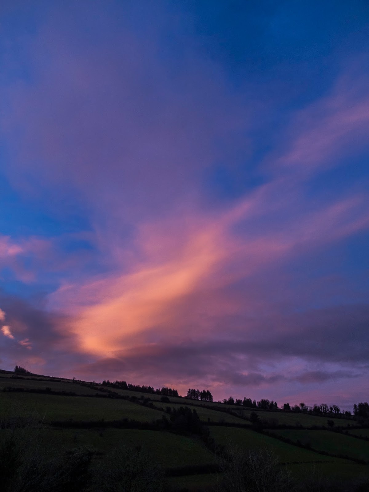 Pink cloud over a hill side in the Boggeragh Mountains in North Cork, Ireland.