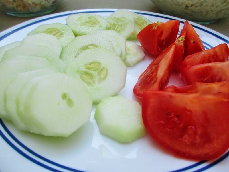 Plate of sliced cucumbers and tomatoes
