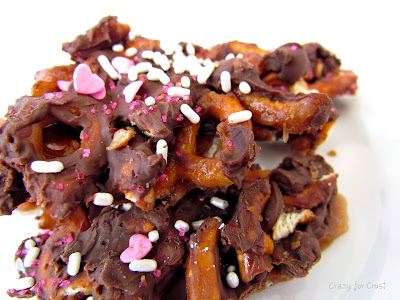 chocolate coated pretzel toffee on white plate with words
