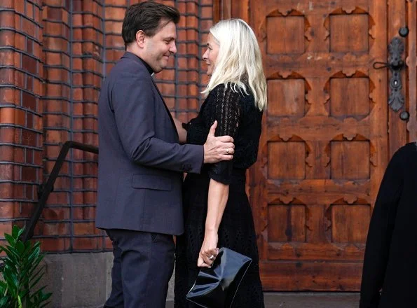 Funeral of Norwegian musician Anne Grete Preus, held at Uranienborg Church in Oslo. Black v-neck half sleeve midi dress