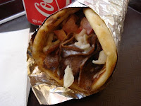 A Halifax donair has spiced meat sliced from a spit, onions, tomatoes, a sweet sauce, wrapped in a pita.