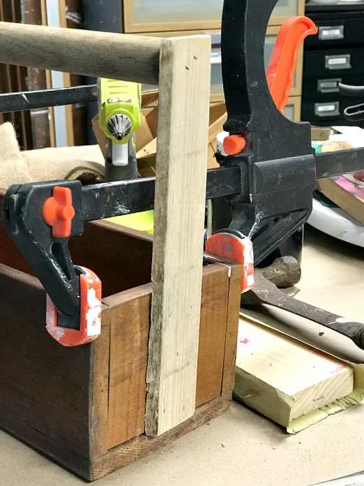 Clamping the handles and sides of a DIY Easter crate.