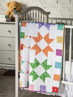 Color Burst Baby Quilt Pattern made using rainbow color fabric