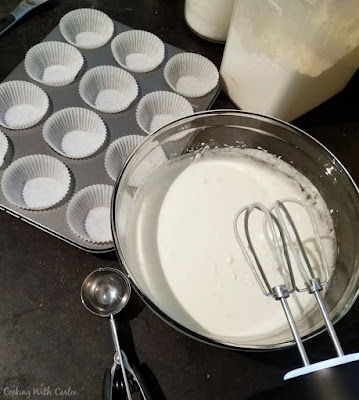 batter in mixing bowl, ready to be scooped into lined cupcake tins