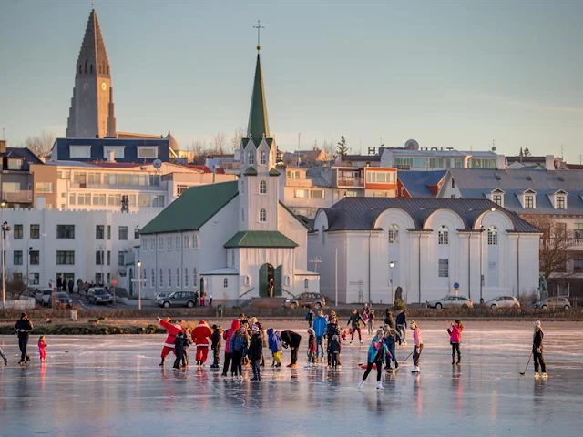 people ice skating out side village in iceland