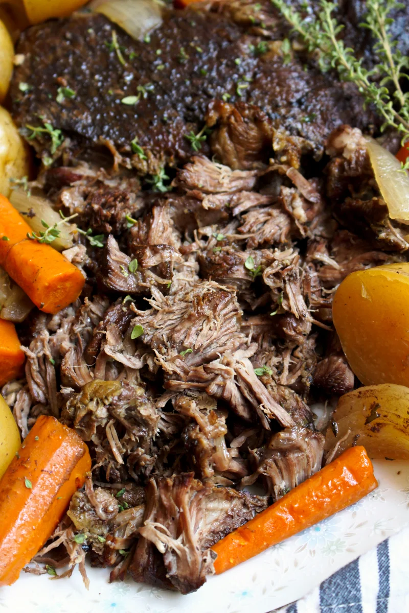 This Perfect Slow Cooker Pot Roast is simmered in the slow cooker to tender perfection!  It is a classic no-fuss dinner that is great for busy weeknights or Sunday supper. #potroast #chuckroast #dinnerrecipe #slowcooker