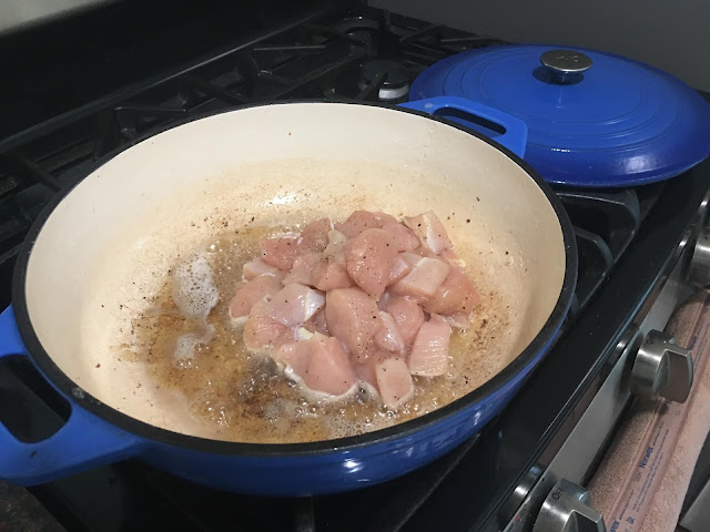 The chicken cooking in the pan.  