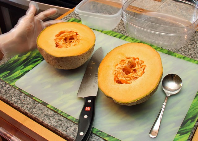 Slice the cantaloupe in half.