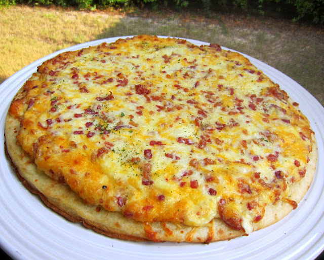 Chef Mickey's Breakfast Pizza - recipe from Walt Disney World - quick and easy breakfast pizza - ready in 10 minutes!! Premade pizza crust topped with eggs, heavy cream, mozzarella, provolone, cheddar and bacon. Great weekday breakfast! #disney #kidfriendly #breakfast