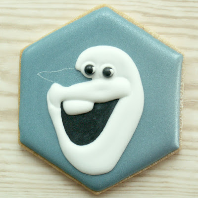 Blue cookie with Olaf's mouth, teeth, eyes, face and lips piped, photo by Honeycat Cookies