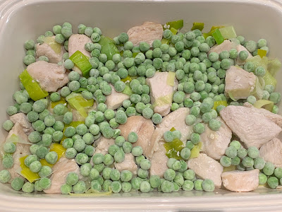 chicken leeks and peas in a casserole dish