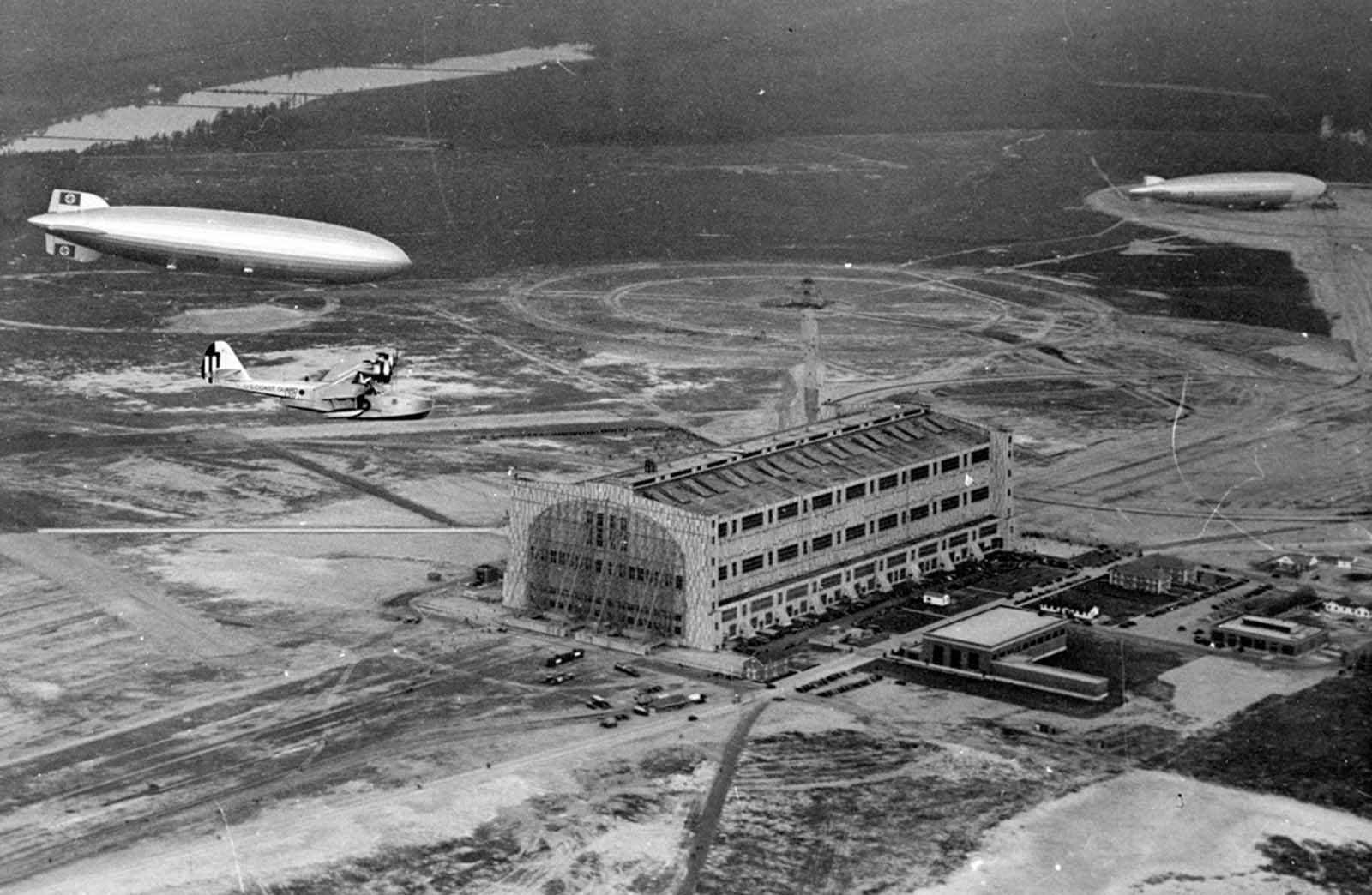 A U.S. Coast Guard plane escorts the Hindenburg to a landing at Lakehurst, New Jersey, on its inaugural flight between Freidrichshafen and Lakehurst in 1936.