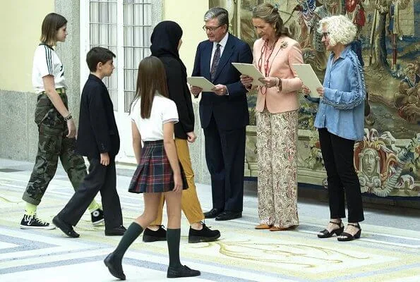 Infanta Elena of Spain wore Boss pumps and Mango pink jacket and Zara print trousers carried Mango clutch