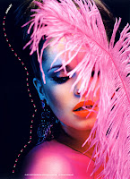 Cheryl Cole holding a pink feather