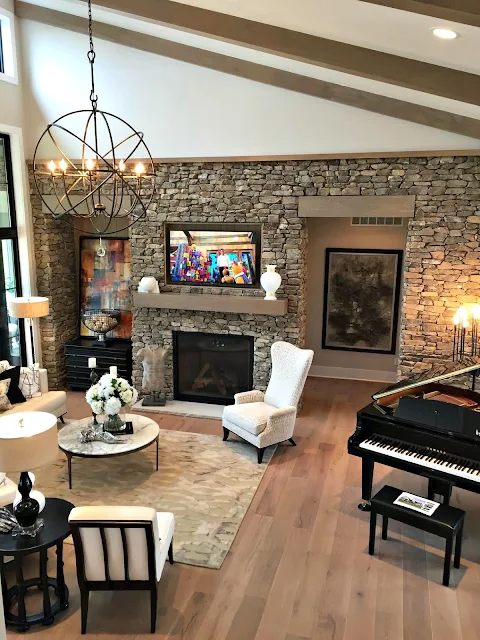 family room with stone walls and wood beams